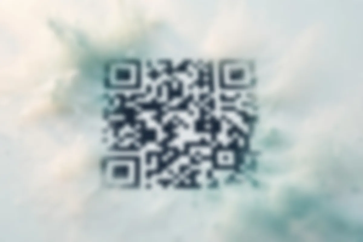A QR code printed on paper dissolving into soft focus at a slight angle, its modules melting into the pale ground at the edges.